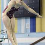 Kenai Central diver Mikaela Pitsch flings herself into the air at the Homer Invite on Friday, Sept. 9, in Homer.