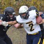 Photo by Joey Klecka/Peninsula Clarion Homer quarterback Jaime Rios (2) stiff arms Nikiski lineman Tyler Litke Saturday at Nikiski High School.