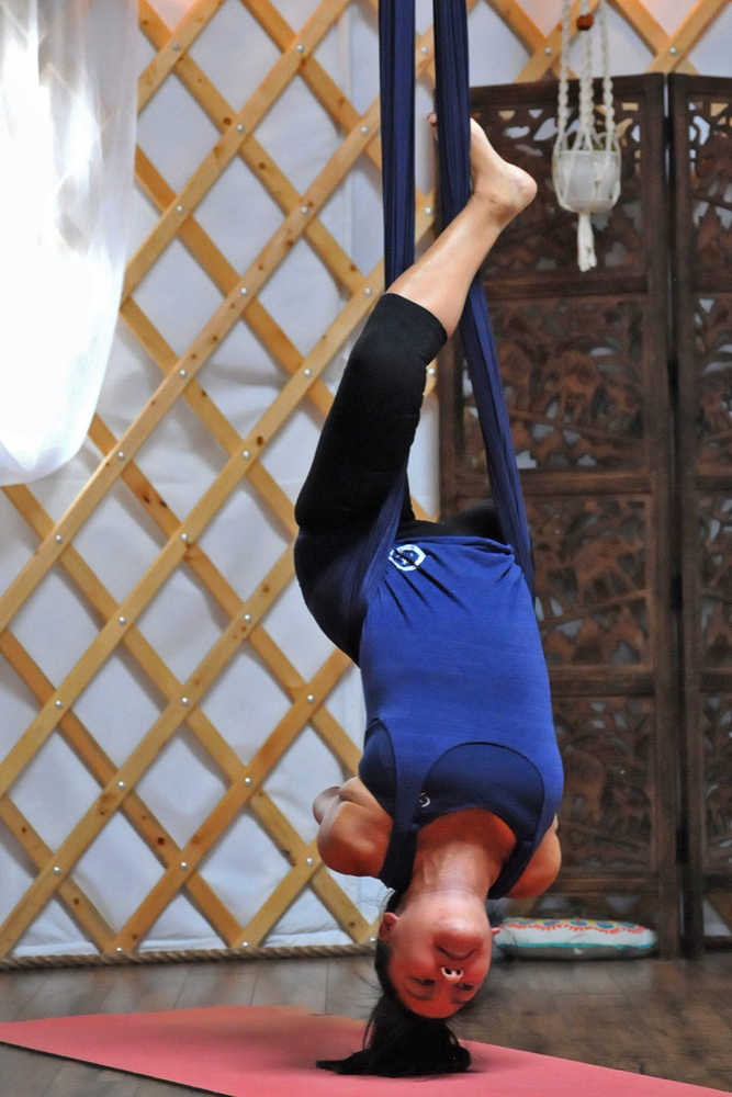 Photo by Elizabeth Earl/Peninsula Clarion A participant strikes a pose during an aerial yoga session at the Yoga Yurt on Monday, Sept. 12, 2016 near Soldotna, Alaska. The Yoga Yurt, a new yoga studio on Kalifornsky Beach Road near the intersection of Poppy Lane, opened this summer, offering aerial and paddleboard yoga as well as more traditional mat yoga classes.