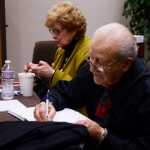 Photo by Megan Pacer/Peninsula Clarion Holocaust survivor Irving Roth and his wife, Myrna Kushman, sign books after Roth's presentation on his story of survival Tuesday, Sept. 20, 2016 at the New Life Assembly of God in Kenai, Alaska. Roth also spoke to students in Nikiski and will travel to Anchorage.