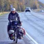 Ben Boettger/Peninsula Clarion Hiromu Jimbo bicycles up the Sterling Highway from Mackey Lake Road, laden with camping and cooking gear, on Wednesday, Sept. 21 outside of Soldotna. The Japanese long-distance cyclist has been riding around the world since 2009 and is presently on his way to Homer. Afterward he plans to ride back up through the central peninsula to Whittier, take a ferry to Valdez, and ride into Canada's Yukon Territory, where he will spend the winter in a village.