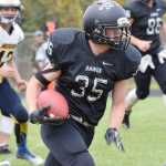 Photo by Joey Klecka/Peninsula Clarion Nikiski running back Patrick Perry carries the ball against Homer last Saturday at Nikiski High School. The Bulldogs face a stiff challenge against Eielson this weekend for their homecoming game.