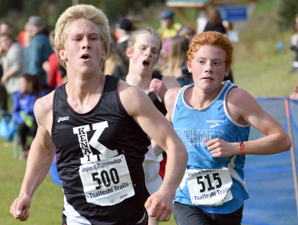 Photo by Jeff Helminiak/Peninsula Clarion Kenai Central's Karl Danielson sprints past Palmer's Connor Owens to finish 11th and earn a state berth Saturday in the Class 4A boys race in the Region III meet at Tsalteshi Trails.