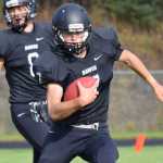 Photo by Joey Klecka/Peninsula Clarion Nikiski running back Michael Eiter carries the ball on a sweep play against Eielson early in Saturday's action at Nikiski High School.