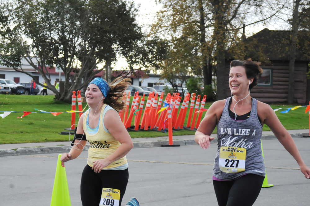 Photo by Elizabeth Earl/Peninsula Clarion Joanna Riley of Homer heads down the home stretch of her half-marathon run in the Kenai River Marathon on Sunday, Sept. 25, 2016 in Kenai, Alaska.