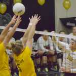 Photo by Joey Klecka/Peninsula Clarion Nikiski senior Ayla Pitt (10) sends the ball over the net into the hands of Kenai Central middle blockers Abby Beck and Emily Koziczkowski (5) Tuesday night at Nikiski High School.