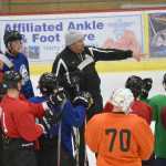Photo by Jeff Helminiak/Peninsula Clarion Kenai River Brown Bears head coach Jeff Worlton instructs the team at practice Wednesday at the Soldotna Regional Sports Complex ahead of the team's home opener tonight.