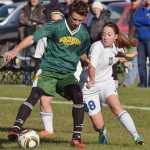 Photo by Joey Klecka/Peninsula Clarion Cook Inlet Academy midfielder Breonna Delon (38) fights for the ball against Birchwood Christian's Bjorn Peterson Thursday at the Aurora Borealis Conference tournament at the Kenai Sports Complex fields.