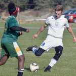 Photo by Joey Klecka/Peninsula Clarion Cook Inlet Academy striker Noah Leaf (9) winds up for the kick against Birchwood Christian Thursday morning at the Aurora Borealis Conference tournament at the Kenai Sports Complex fields.