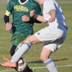 Photo by Joey Klecka/Peninsula Clarion Cook Inlet Academy defenders Adara Warren (white) vies for the ball against Birchwood Christian's Stephen Sterling Thursday morning at the Kenai Sports Complex fields.