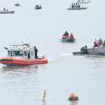 Photo by Megan Pacer/Peninsula Clarion In this July 22, 2016 photo, members of the Kenai Fire Department and Kenai Police Department tow two boats behind them - one that capsized and another that came to the rescue - while passengers work to bail out the capsized boat on the Kenai River in Kenai, Alaska. The three people in the capsized vessel were all saved from the water, and no one was harmed.