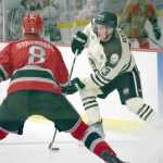 Photo by Jeff Helminiak/Peninsula Clarion Kenai River Brown Bears forward Tyler Rock pulls up in the offensive zone against New Jersey Titans defenseman Oskar Stromberg on Friday at the Soldotna Regional Sports Complex.