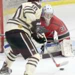 Photo by Jeff Helminiak/Peninsula Clarion New Jersey Titans goaltender Brandon Bussi protects the net from Kenai River forward Chad Lopez on Friday at the Soldotna Regional Sports Complex.