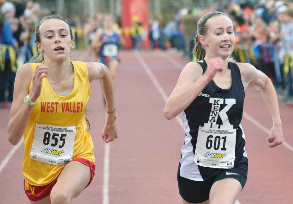 Photo by Joey Klecka/Peninsula Clarion Kenai Central's Jaycie Calvert (601) sprints to the finish with West Valley's Maggie Druckenmille in Saturday's 4A girls race at the Bartlett High School trails in Anchorage.