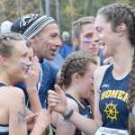 Photo by Joey Klecka/Peninsula Clarion Homer coach Bill Steyer (center) congratulates his girls team for winning the 1-2-3A championship Saturday at the Bartlett High School trails, as Megan Pitzman (570) talks to teammate Autumn Daigle.