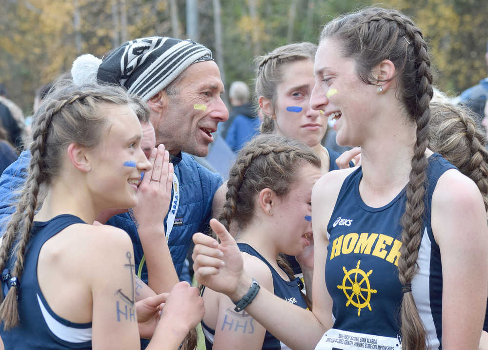 Photo by Joey Klecka/Peninsula Clarion Homer coach Bill Steyer (center) congratulates his girls team for winning the 1-2-3A championship Saturday at the Bartlett High School trails, as Megan Pitzman (570) talks to teammate Autumn Daigle.