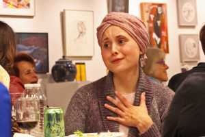 Ben Boettger/Peninsula Clarion Ivy Howland hesitates before bidding on the lino-block print "Great Horned Owl" by Kathryn Zerbe at the Kenai Fine Arts Center's annual Harvest Art Auction fundraiser on Saturday, Oct. 1 in Old Town Kenai. Howland ended up winning her bid on the black and white owl print for $110.