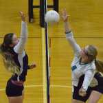 Photo by Joey Klecka/Peninsula Clarion Homer middle hitter Mary Hana Bowe (left) blocks a shot from Nikiski's Jamie Yerkes Tuesday at Nikiski High School.