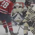 Photo by Joey Klecka/Peninsula Clarion Brown Bears goalie Bailey Seagraves eyes the puck amidst a battle between Tomahawks forward Alex Singley and Brown Bears defenseman Christopher Lipe, Wednesday night at the Soldotna Regional Sports Complex.