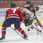 Photo by Jeff Helminiak/Peninsula Clarion Kenai River forward Evan Butcher skates the puck up the ice against Johnstown (Pennsylvania) defenseman Adam Pilewicz on Friday at the Soldotna Regional Sports Complex.