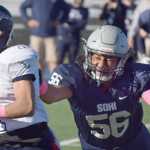 Photo by Joey Klecka/Peninsula Clarion Soldotna lineman Aseli Finau (56) attempts to tackle North Pole running back James Bartley in the first quarter of Saturday's medium-schools semifinal game at Palmer High School.