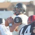 Nikiski quarterback Ian Johnson looks downfield for a receiver during third quarter action of the small schools state semifinal high school playoff football game between the Bulldogs and the Eielson Ravens Saturday afternoon, October 8, 2016 on Buck Nystrom Field at Ben Eielson High School. Eric Engman/News-Miner