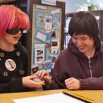 Ben Boettger/Peninsula Clarion Blindfolded River City Academy student Amelia Johnson feels the shape of a stone egg, presented to her by fellow student Maria Maes, during River City's Blindness Challenge on Thursday, Oct. 13 in Soldotna. Maes, a blind student, helped organize a series of events that allowed blinfolded students to experience the world tactilely and to use the tools blind people use for drawing, writing, typing, and other tasks.