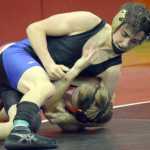 Photo by Jeff Helminiak/Peninsula Clarion Soldotna's Gideon Hutchison prepares to pin Kenai Central's Tyler Vaughn on Saturday at the Luke Spruill Invitational at Kenai Central High School.