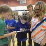 Photo by Megan Pacer/Peninsula Clarion Fifth grader Spencer Co, a 10-year-old from Fireweed Academy, makes final adjustments to his team's device while teammate Christian Matthews, 10, eyes up the lane it will travel down during the annual Mind A-Mazes competition Saturday, Oct. 15, 2016 at Soldotna Prep in Soldotna, Alaska.