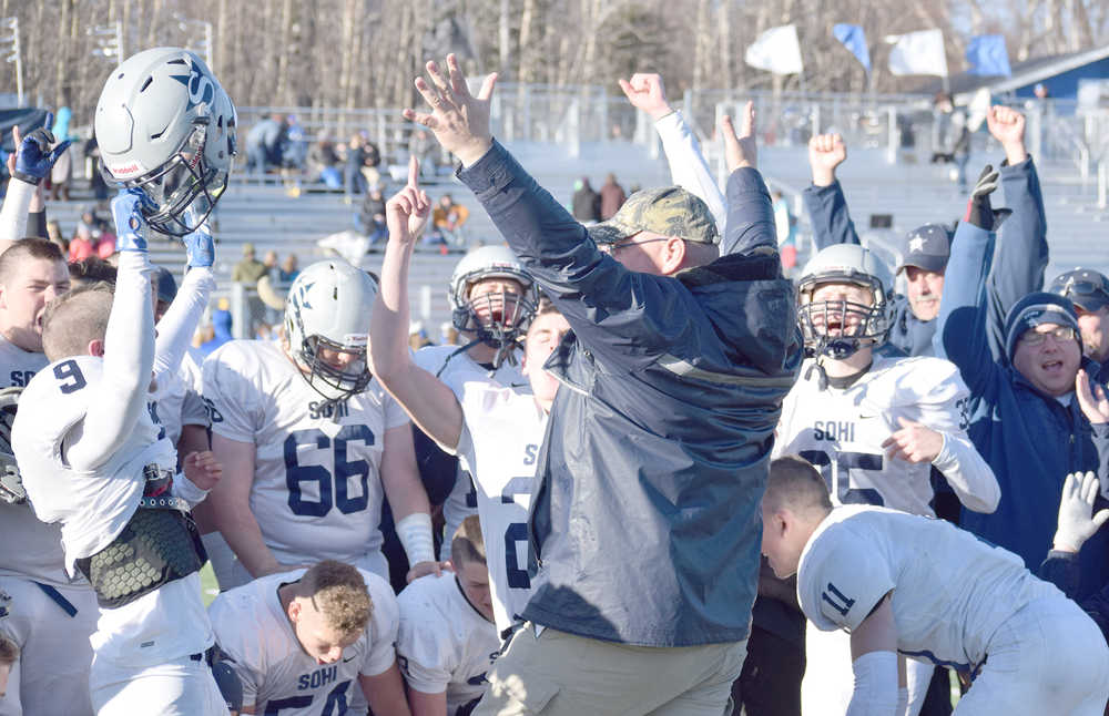 Photo by Joey Klecka/Peninsula Clarion Soldotna coach Galen Brantley Jr. celebrates with his players after winning a school-record fifth straight state football championship Saturday afternoon at Palmer High School.
