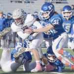 Photo by Joey Klecka/Peninsula Clarion Soldotna running back Jace Urban tries to shed a tackle by Palmer's Jacoby Glenn (31) Saturday in the medium-schools state championship game at Palmer High School.