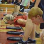Photo by Joey Klecka/Peninsula Clarion Kenai Central sophomore Jarrett Wilson (in red) works hard among a line of boys competing in the Fight Gone Bad competition Wednesday night at Kenai Central High School.