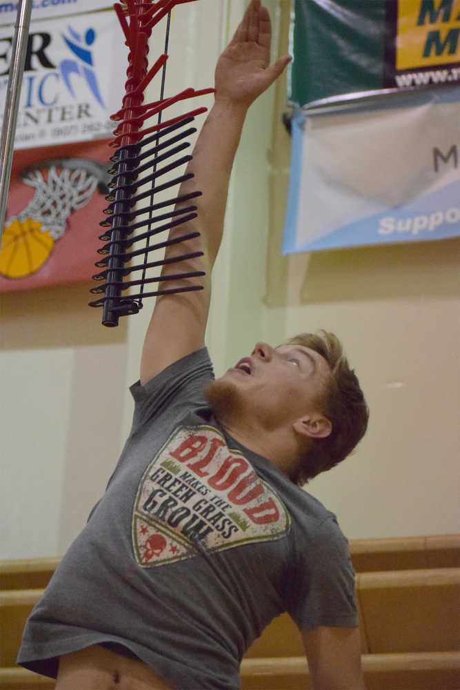 Photo by Joey Klecka/Peninsula Clarion Nikiski senior Michael Meyers reaches high in the vertical jump challenge Wednesday night at Kenai Central High School.