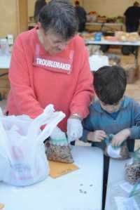 Kaye Fariday helps a boy /name??// from Fireweed Academy bag food at the Homer Food Pantry on Sept. 26 at Homer United Methodist Church.