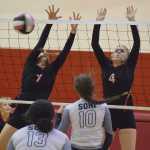 Photo by Joey Klecka/Peninsula Clarion Kenai Central middle blocker Cierra King (7) and Caleigh Jensen form a block from Soldotna Tuesday night at Kenai Central High School.