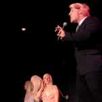 Photo by Elizabeth Earl/Peninsula Clarion Donald Trump (Tyler Payment) sings a parody song about his plans to build a wall along the U.S.-Mexico border during a dress rehearsal for Triumvirate Theatre's "Lame Ducks and Dark Horses" political satire play Monday, Oct. 24, 2016 near Kenai, Alaska.