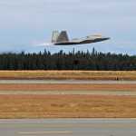 Photo by Ben Boettger/Peninsula Clarion A Kenai Muncipal Airport employee unblocks the wheels of an F-22 Raptor fighter jet as it prepares to take off on Friday, Oct. 28 2016 at the Kenai Municipal Airport. Two F-22s landed in Kenai Friday to evaluate the airport's suitability as an alternative landing site when weather prevents them from landing at their home airfield, Anchorage's Elmendorf Air Force Base.
