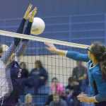Photo by Joey Klecka/Peninsula Clarion Nikiski middle hitter Ayla Pitt sends the ball by Soldotna's Ella Stenga (3) Saturday at Soldotna High School.