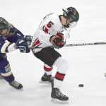 Photo by Joey Klecka/Peninsula Clarion Kenai Central forward Levi Mese (5) fights for the puck with Homer's Tucker Weston, Thursday evening at the Soldotna Regional Sports Complex.