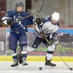 Photo by Jeff Helminiak/Peninsula Clarion Homer's Tim Blakely and Soldotna's Braxton Urban try to corral the puck Friday in the Peninsula Ice Challenge at the Soldotna Regional Sports Complex.
