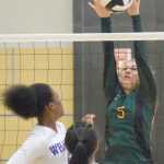Photo by Joey Klecka/Peninsula Clarion Seward middle hitter Maggie Adkins (5) blocks a shot from Barrow's Milya Wright Thursday morning at the Class 3A state volleyball tournament at the Alaska Airlines Arena in Anchorage.