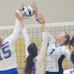 Photo by Joey Klecka/Peninsula Clarion Nikiski middle Bethany Carstens (7) blocks a shot from Monroe Catholic's Maija Hajdukovich (15) and Madlyn Leslie on Thursday morning at the Class 3A state volleyball tournament at the Alaska Airlines Arena in Anchorage.