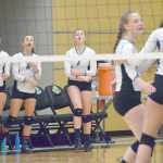 Photo by Joey Klecka/Peninsula Clarion (L to R) Nikiski's Brianna Vollertsen, Bethany Carstens and Rylee Jackson cheer on their teammates Thursday morning at the Class 3A state volleyball tournament.