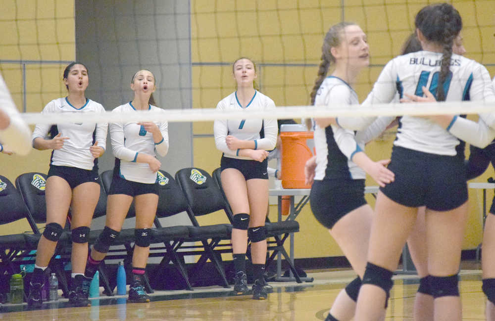 Photo by Joey Klecka/Peninsula Clarion (L to R) Nikiski's Brianna Vollertsen, Bethany Carstens and Rylee Jackson cheer on their teammates Thursday morning at the Class 3A state volleyball tournament.
