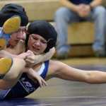 Photo by Jeff Helminiak/Peninsula Clarion Kenai Central's Keaton Logston works his way to a pin over Soldotna's Amanda Wylie on Thursday in a dual meet at Soldotna Prep.