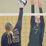 Photo by Joey Klecka/Peninsula Clarion Seward's Coral Petrosius (7) puts a block on Monroe Catholic's Maija Hajdukovich Friday morning at the Class 3A state volleyball tournament held at the Alaska Airlines Arena in Anchorage.