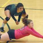 Photo by Joey Klecka/Peninsula Clarion Seward libero Kimmie Hubbard (in pink) digs for a ball with teammate Tia Miranda, Friday against Monroe Catholic in the Class 3A state volleyball tournament held at the Alaska Airlines Arena in Anchorage.
