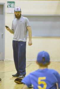 Photo by Joey Klecka/Peninsula Clarion Corpus Christi pitcher Cy Sneed keeps time as he works with young baseball fans Saturday afternoon at the Kenai Boys & Girls Club.