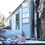 Photo by Megan Pacer/Peninsula Clarion Debris litters the back porch of a mobile home that caught fire Tuesday, Nov. 22, 2016 on Blanch Street, off of Kalifornsky Beach Road, near Soldotna, Alaska. The back bedroom and bathroom area of the mobile home caught fire Tuesday afternoon, though firefighters were able to put it out within minutes and none of the occupants were hurt.