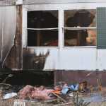 Photo by Megan Pacer/Peninsula Clarion Debris litters the ground outside of a mobile home that caught fire Tuesday, Nov. 22, 2016 on Blanch Street, off of Kalifornsky Beach Road, near Soldotna, Alaska. Firefighters were able to put out the blaze in the back bedroom and bathroom area of the mobile home within minutes and none of the occupants were hurt.